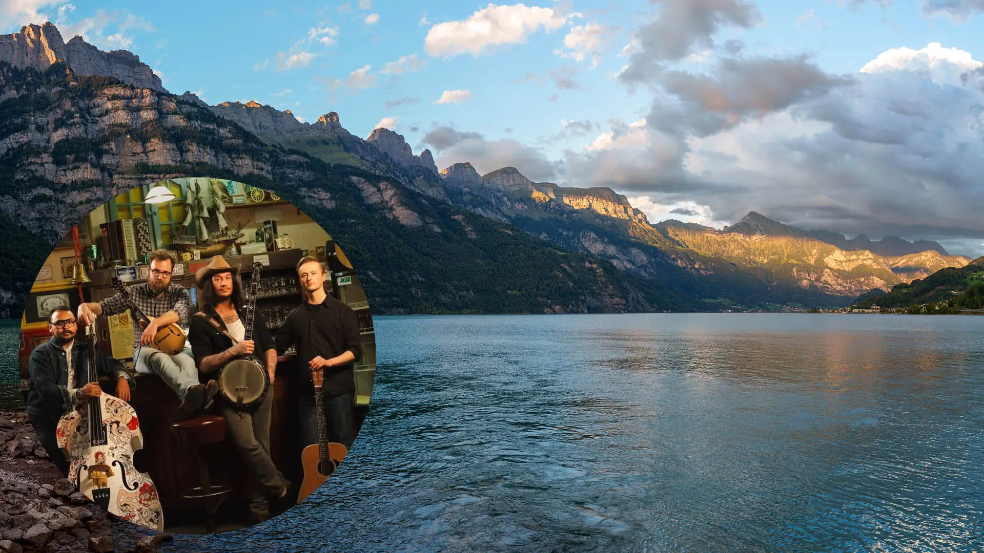 A small group rides on their mountain bikes along a gravel path, with a blue lake and a castle in the background.